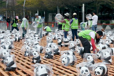Paper pandas in massive art display get their own raincoats