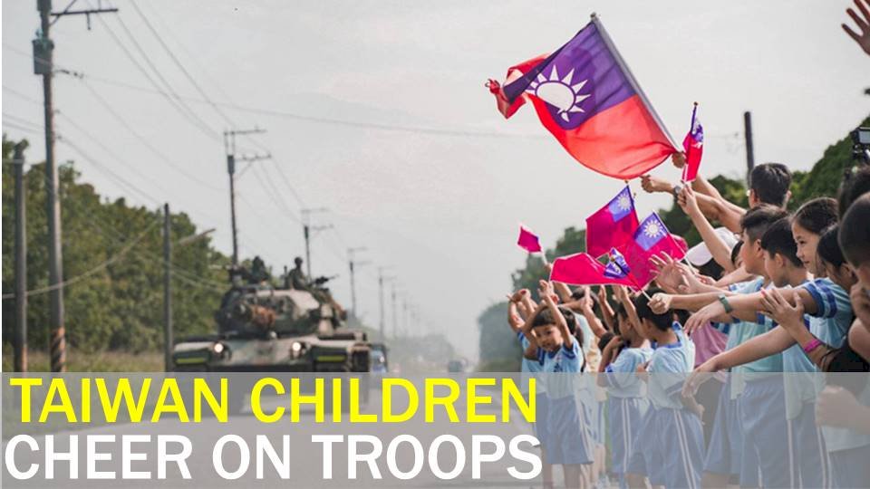 School children cheer on nation’s military during exercises